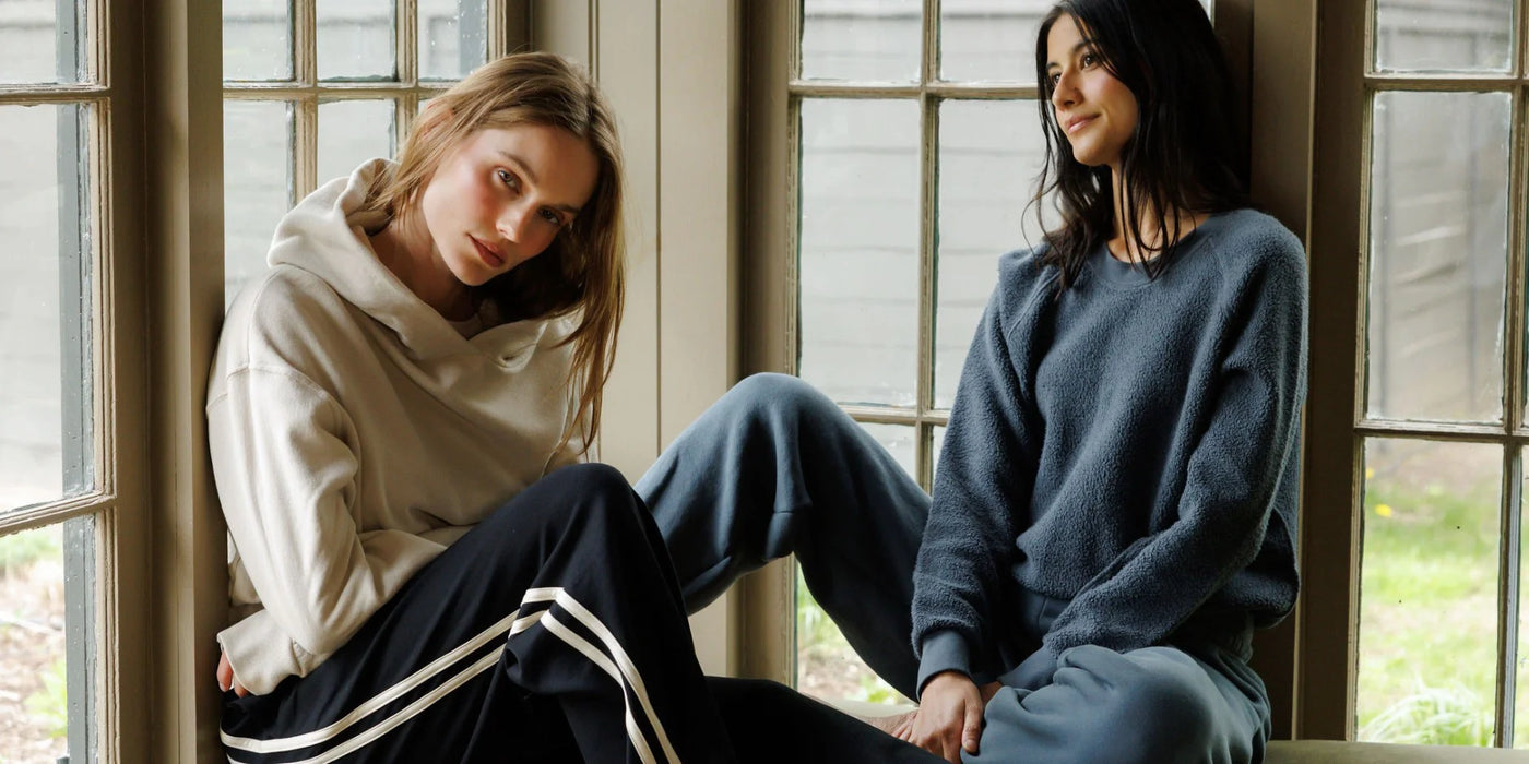 perfectwhitetee cozy essentials - ladies sitting on a bench wearing our core styles in aug colors.