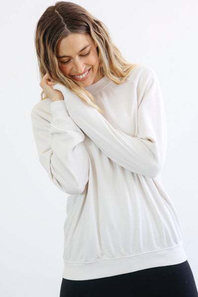 The perfect slightly oversized sweatshirt.  Longer length so it's easy with leggings, or perfectly paired with our Nash joggers. Made with 100% cotton french terry. This sweatshirt has a classic fit and vintage feel. Pictured in Sugar (off white).
