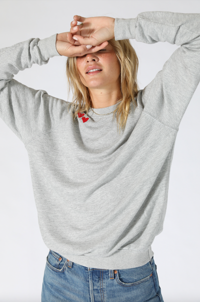 Limited edition sweatshirt with hearts along the collar. Easy with leggings, oversized, you’re going to love the vintage feel of this 100% cotton french terry sweatshirt. Pictured in Heather Grey with Red Hearts.
